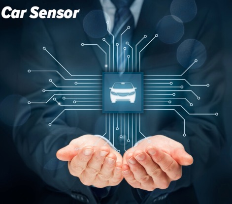 Man's hands holding an electrified circuit board, showcasing automotive sensor electronics used in vehicles.